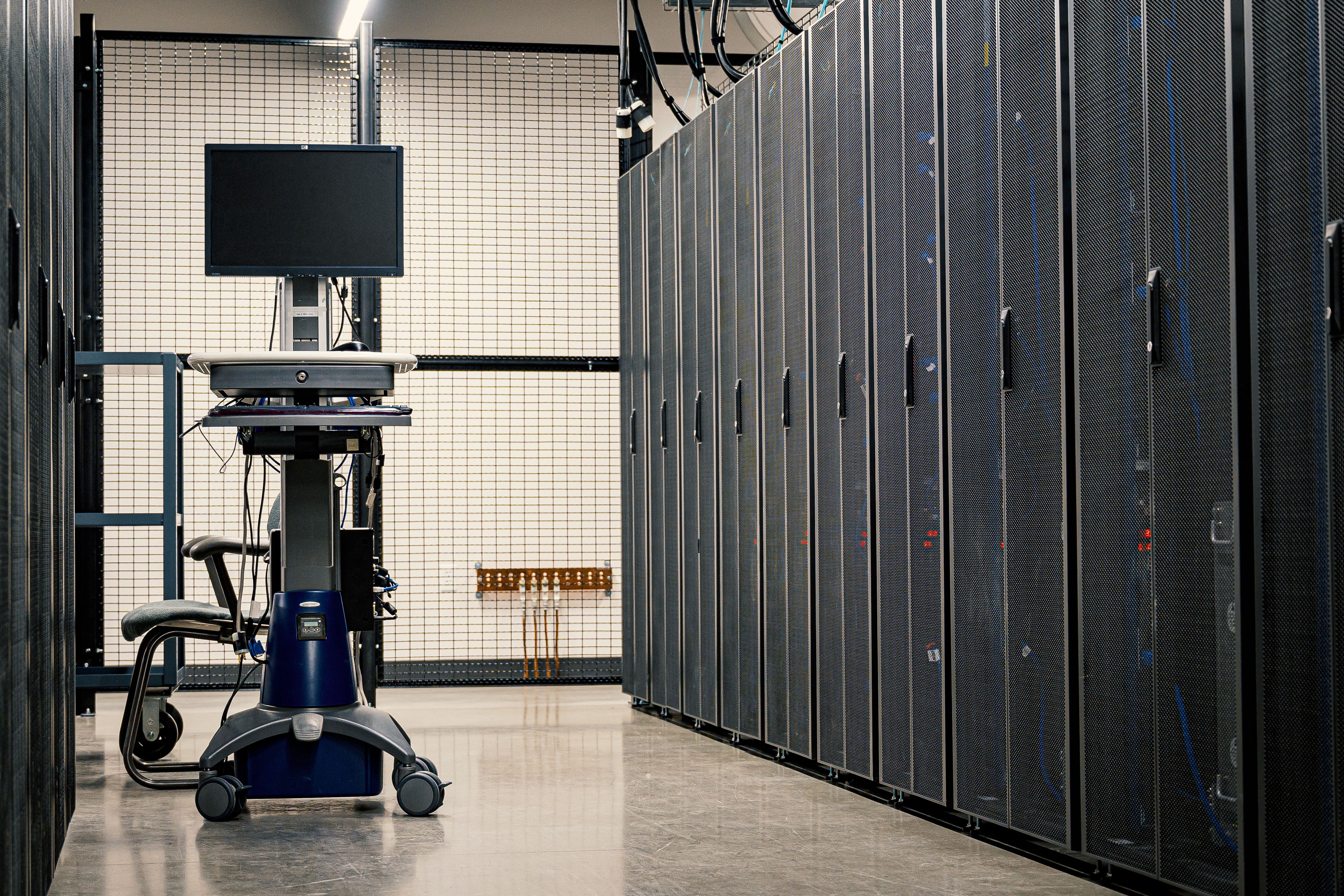 Technician working with network equipment in a datacenter rack